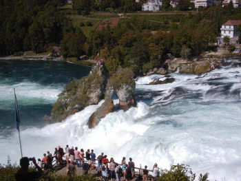 Panoramic view of people on sea against sky