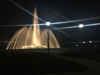 Illuminated lights against sky at night