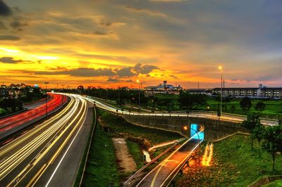 High angle view of light trails on road against sky during sunset