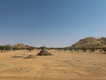 Scenic view of desert against clear blue sky