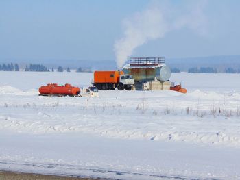 Lifeguard hut on snow against sky