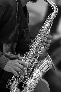 Midsection of man playing saxophone