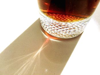 Close-up of beer glass against white background