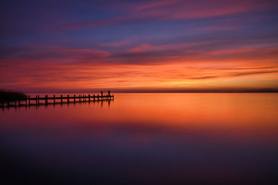 Scenic view of sea against romantic sky at sunset