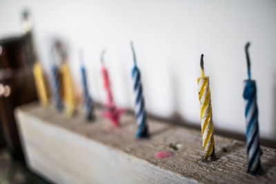 Close-up of colorful candles on wood