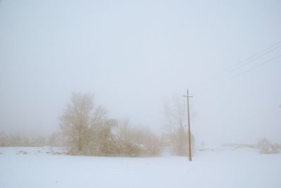 Snow covered landscape against clear sky