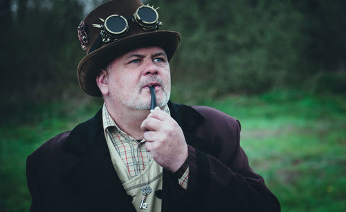 Portrait of man in steampunk outfit  outdoors
