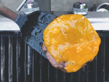 High angle view of yellow meat on barbecue grill