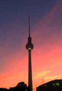 Low angle view of fernsehturm against sky during sunset