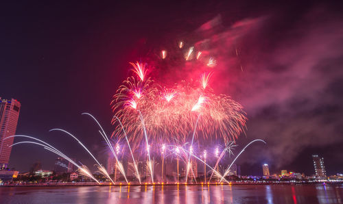 Low angle view of firework display against sky at night