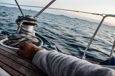 Low section of man in boat sailing on sea