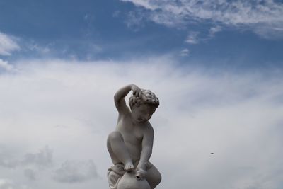 Human statue against sky