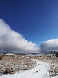 Scenic view of landscape against sky during winter