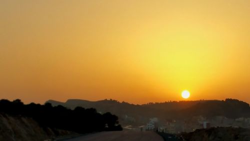 Scenic view of silhouette landscape against romantic sky at sunset