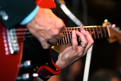 Close-up of hands playing guitar