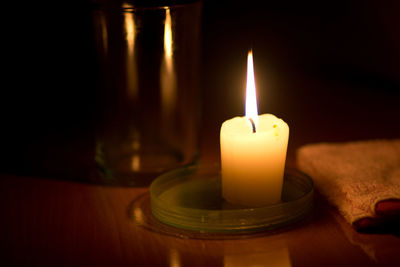 Close-up of illuminated candles on table