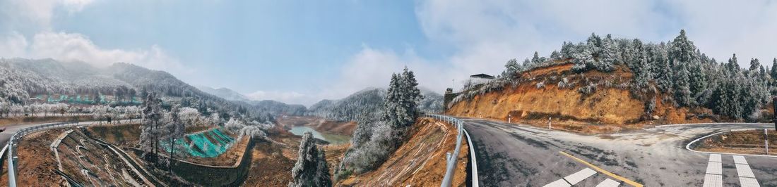 Panoramic view of road against sky during winter