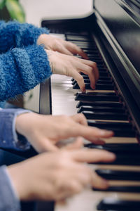Cropped image of women playing piano