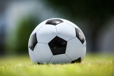 Close-up of soccer ball on grassy field