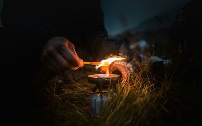 Cropped hand of person burning candles