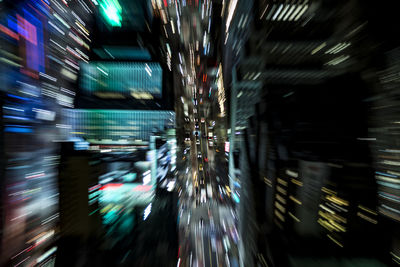 Defocused image of illuminated lights in city at night