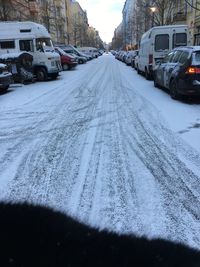 Snow covered road in city