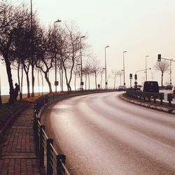 Empty road with trees in background