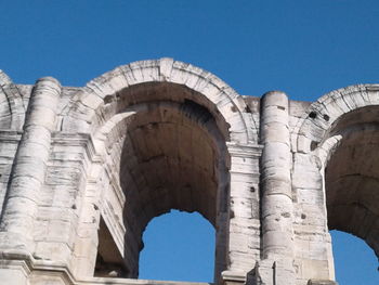 Low angle view of historical building against blue sky