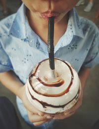 Midsection of boy drinking chocolate