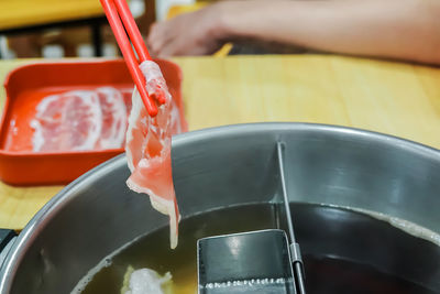 Close-up of person preparing food in kitchen
