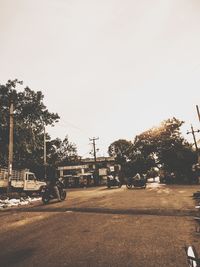 Cars on street against clear sky