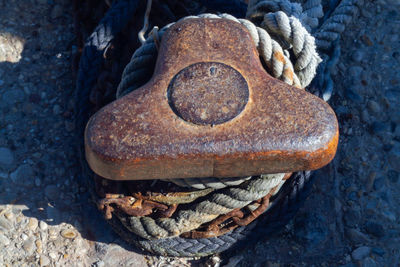 Old iron mooring bollard with tetrapod shape at at marina of santa