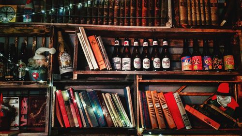 Books and bottles in shelves at store