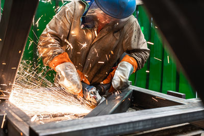 Man cutting metal at workshop