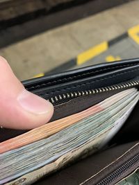 Close-up of hand holding wallet 