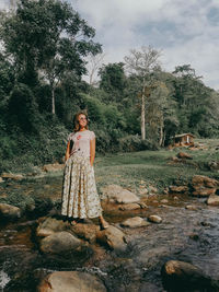 Portrait of woman standing on field