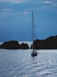 Sailboat sailing on sea against sky