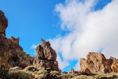 Low angle view of rock formations against sky