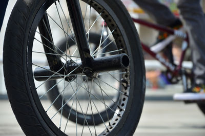 Close-up of bicycle wheel on street