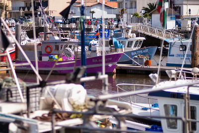 Boats moored in harbor at lake