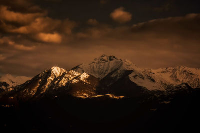 Scenic view of snowcapped mountains against sky during sunset in locarno at the lago maggiore. 