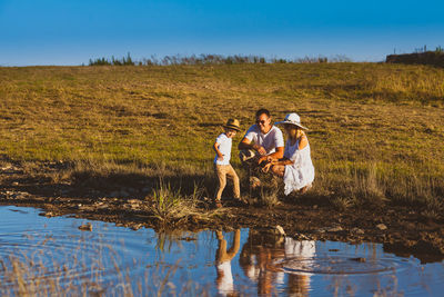 Family enjoying near pond