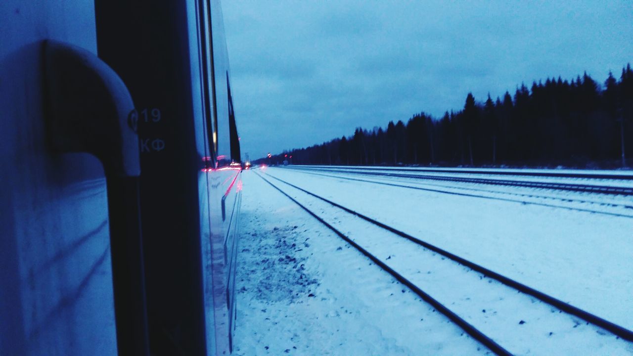 VIEW OF RAILROAD TRACKS THROUGH WINDOW