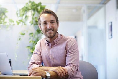 Portrait of young businessman using smart phone