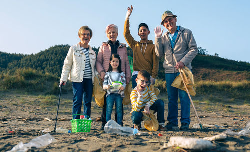 Portrait of happy family standing at beach