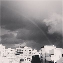 Buildings against cloudy sky