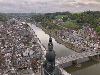 High angle view of river amidst cityscape against sky