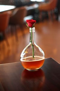 Close-up of rose in jar on table