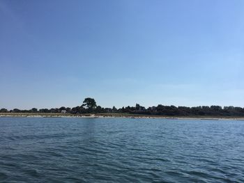 Scenic view of sea against clear blue sky