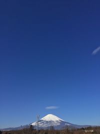 Scenic view of mountains against clear blue sky